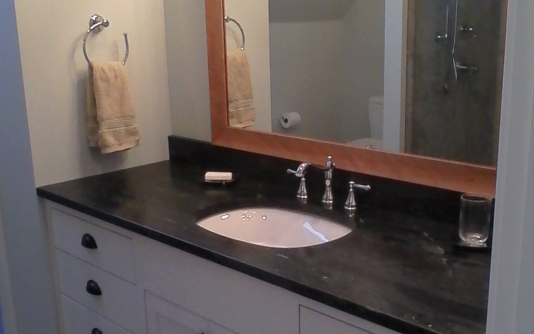 Large white vanity with slab drawer fronts and shaker panel doors.