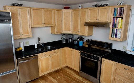 Clear maple kitchen cabinets with shaker doors and slab drawer fronts